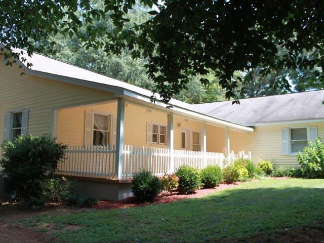 1001 Shirley Road Royston, GA 30662 - Photo 1 of 1 a view of a house with a yard and potted plants