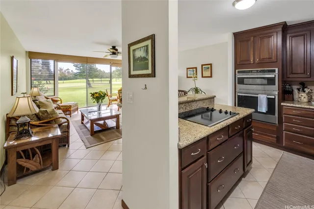 a kitchen with a stove a sink and a refrigerator