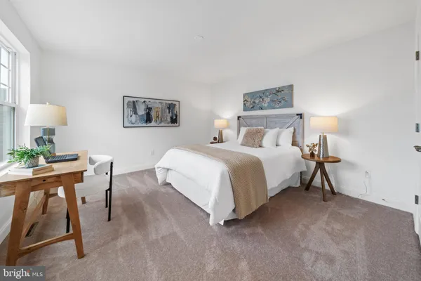 a bedroom with a bed and a desk