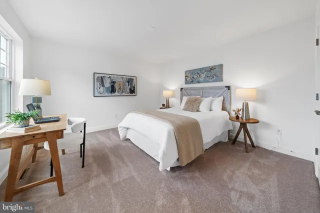 a bedroom with a bed and a desk