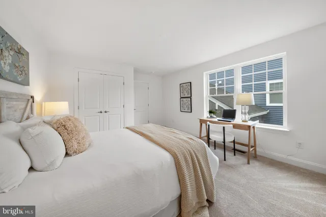 a bedroom with a bed and a table in it