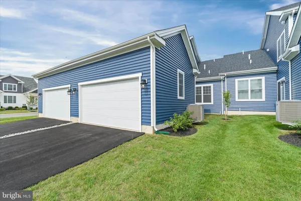 a backyard of a house with plants and garden