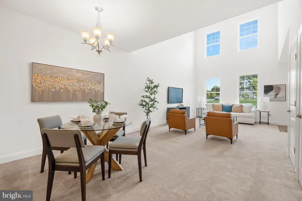 a view of a dining room with furniture and a chandelier