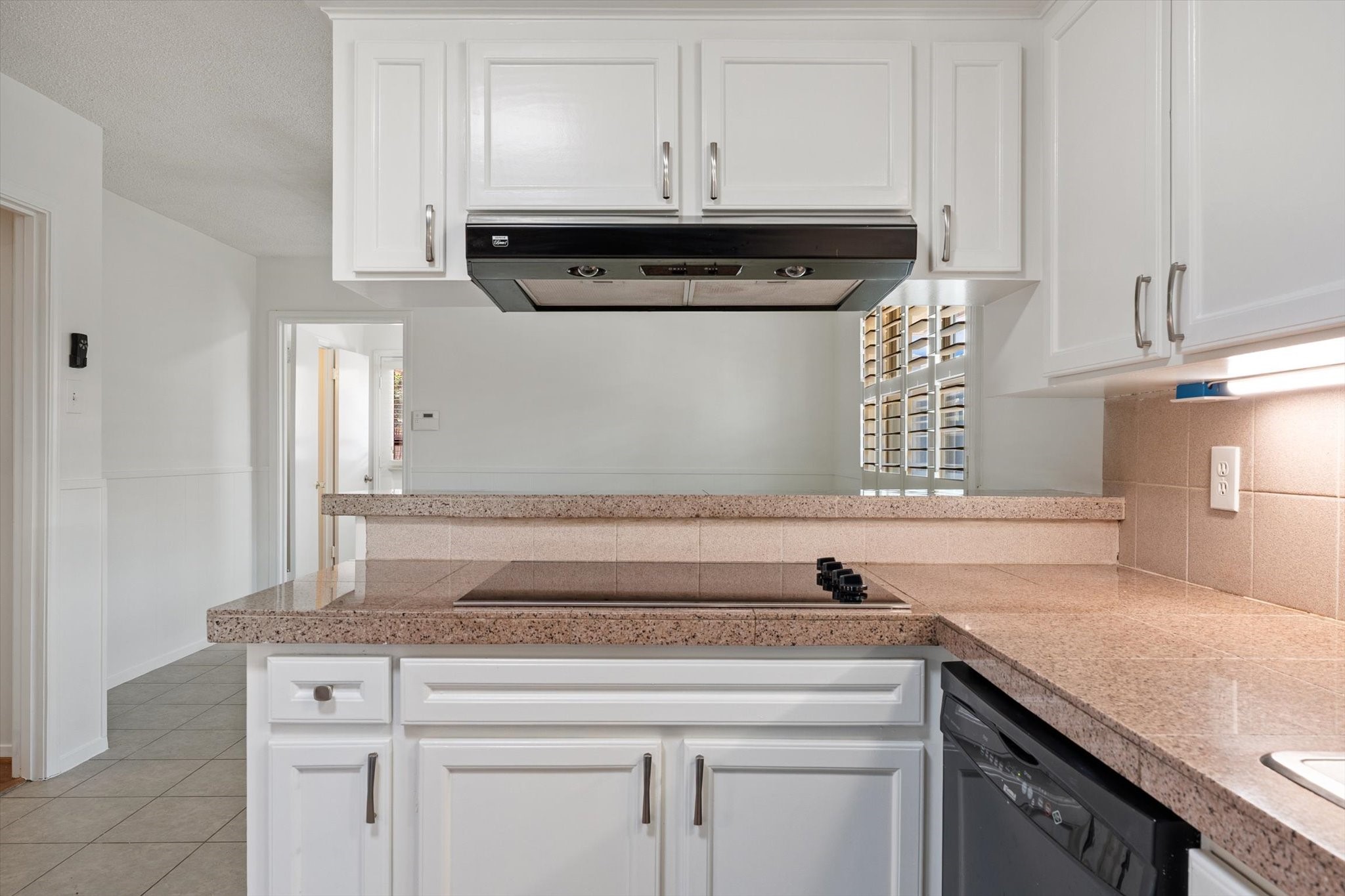983 West Donovan Street Houston, TX 77091 - Photo 25 of 46 Kitchen view 2 showing more cabinet space, electric cooktop, range, and dishwasher