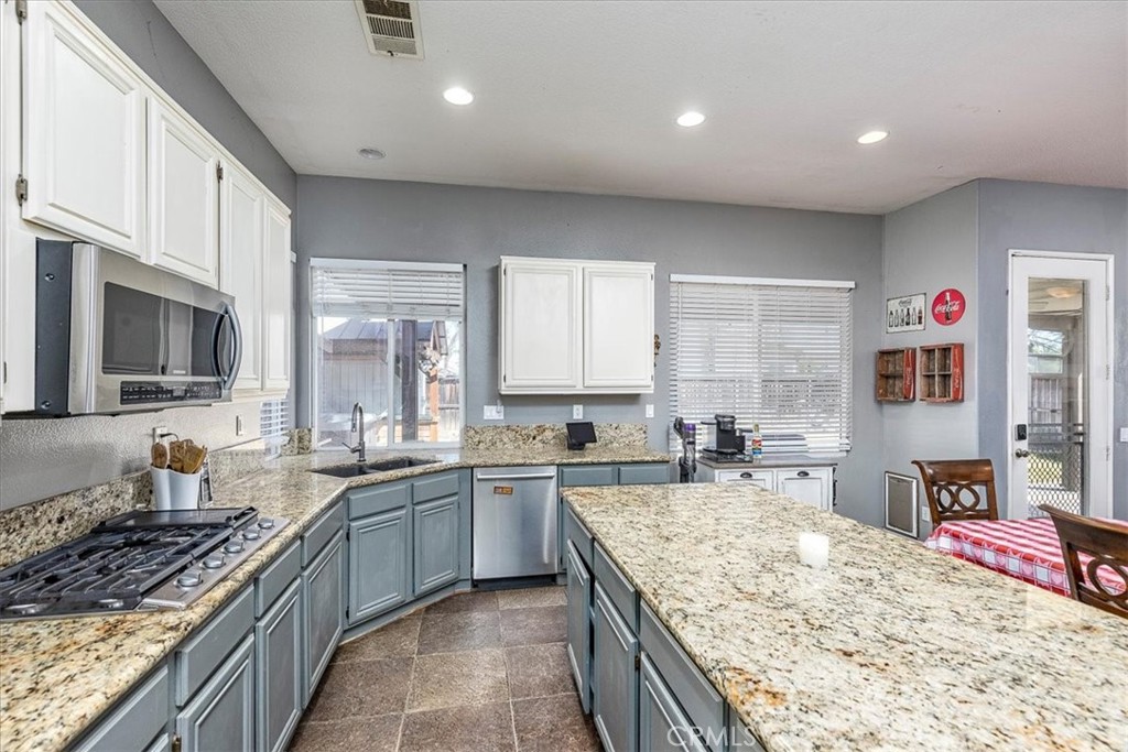 31982 Genoa Street Winchester, CA 92596 - Photo 11 of 49 Slab granite counters. Stainless steel appliances. Windows looking out to back yard.