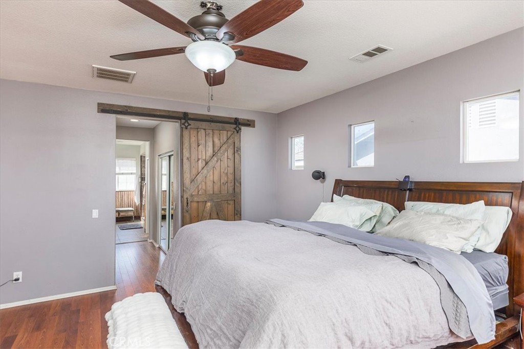 31982 Genoa Street Winchester, CA 92596 - Photo 18 of 49 Primary suite with sliding barn door into adjoining bath.