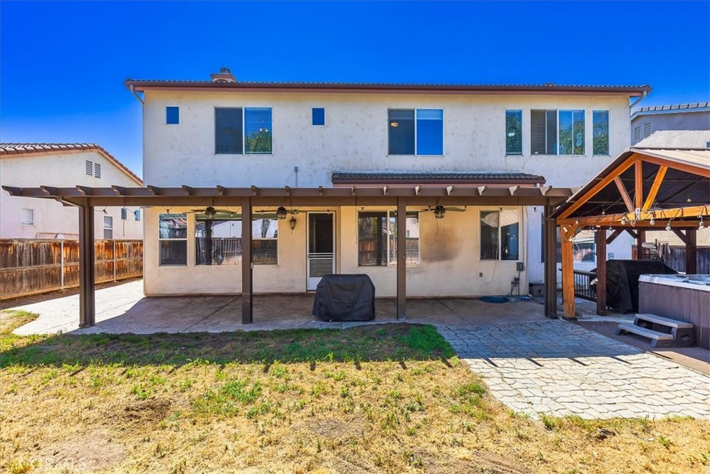 31982 Genoa Street Winchester, CA 92596 - Photo 40 of 49 Rear Exterior with stamped concrete patio and Alumawood patio with 3 ceiling fans.