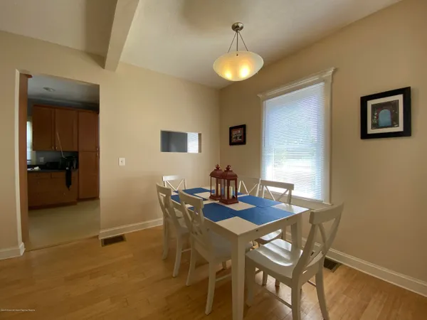 a view of a dining room with furniture and a chandelier