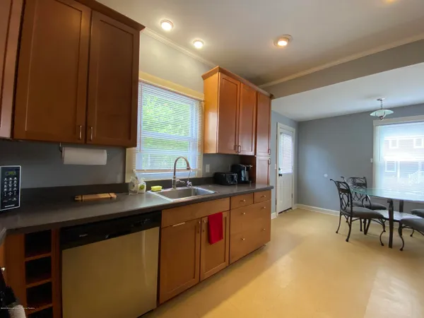 a kitchen with stainless steel appliances granite countertop sink stove top oven and cabinets