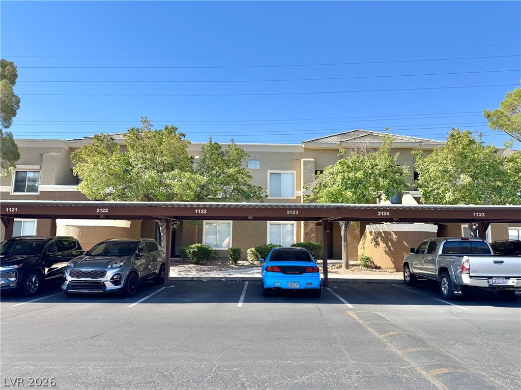 8070 West Russell Road, Unit 2121 Las Vegas, NV 89113 - Photo 1 of 22 Covered parking offers convenience, shielding vehicles from elements in this residential complex.