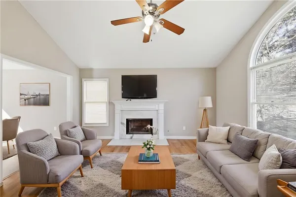 a living room with furniture flat screen tv and a fireplace