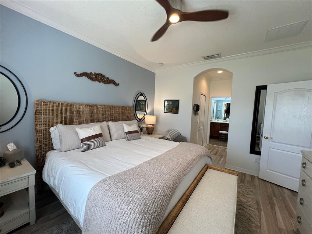 24401 Manchester Trail Port Charlotte, FL 33980 - Photo 12 of 47 a spacious bedroom with a bed a mirror and windows