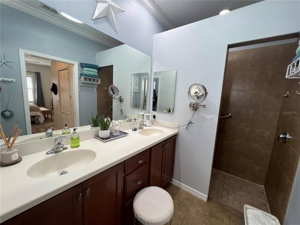 24401 Manchester Trail Port Charlotte, FL 33980 - Photo 13 of 47 a bathroom with a double vanity sink and mirror