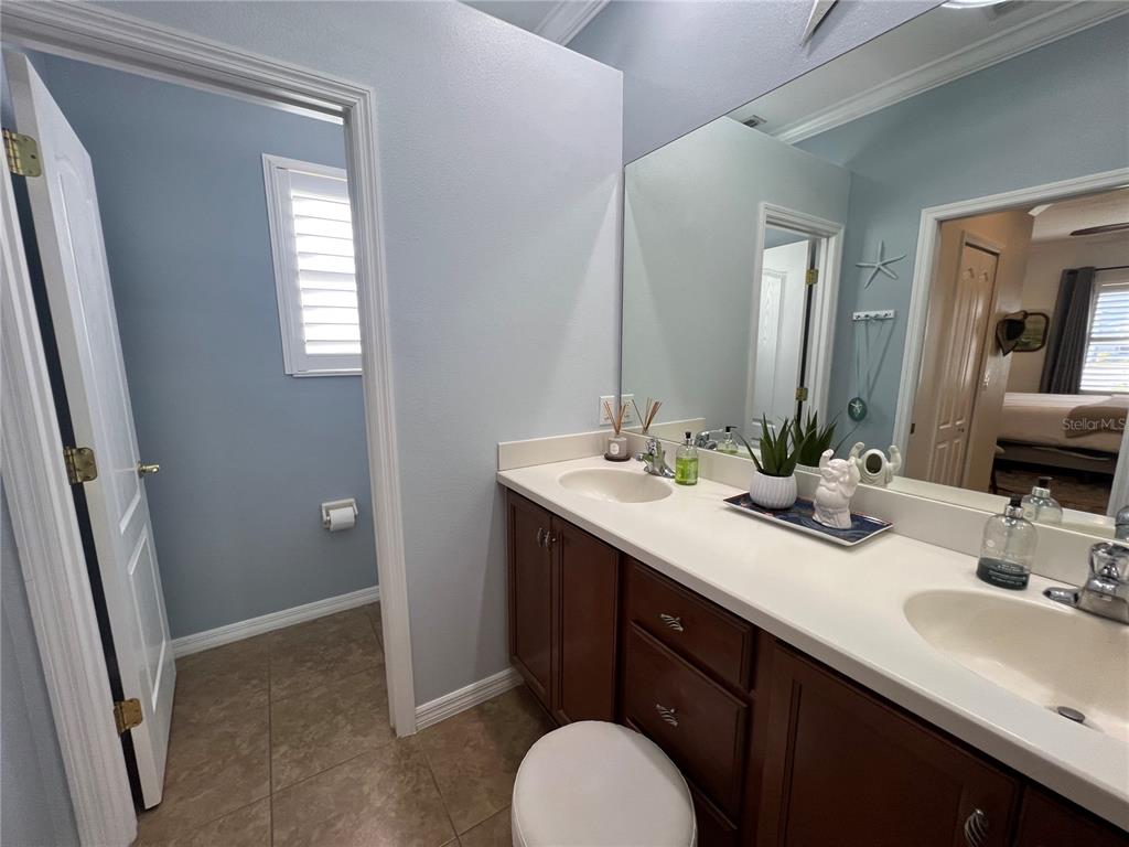 24401 Manchester Trail Port Charlotte, FL 33980 - Photo 15 of 47 a bathroom with a double vanity sink and a mirror