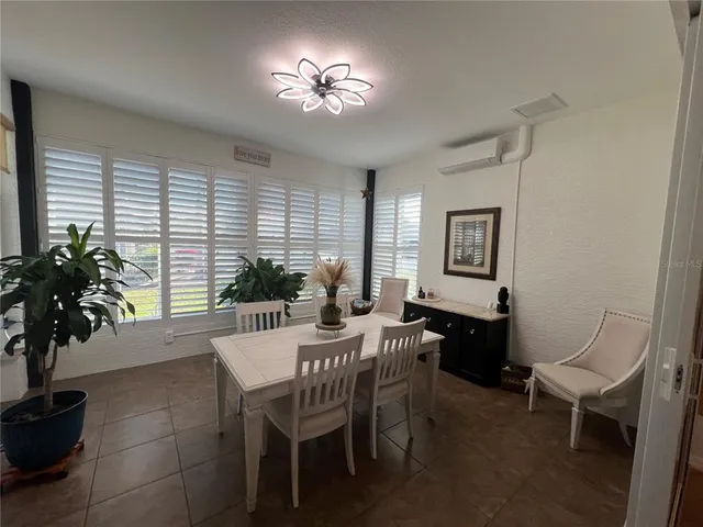 a view of a dining room with furniture and window