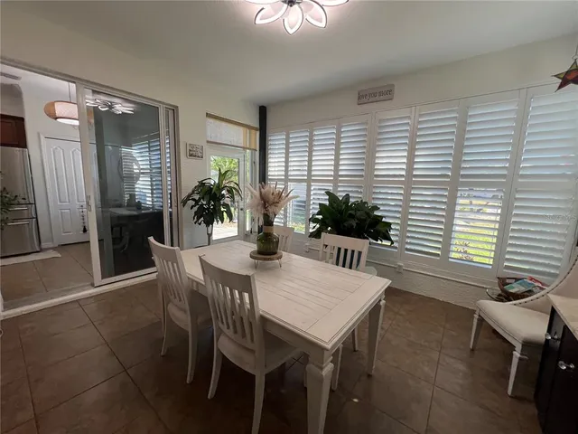 a view of a dining room with furniture and chandelier