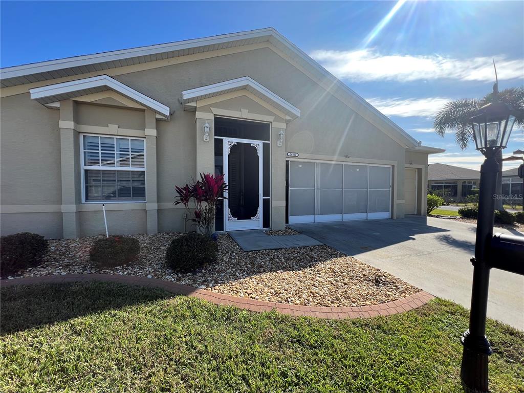 24401 Manchester Trail Port Charlotte, FL 33980 - Photo 2 of 47 a front view of a house with garden