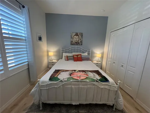a bedroom with a bed and a chandelier