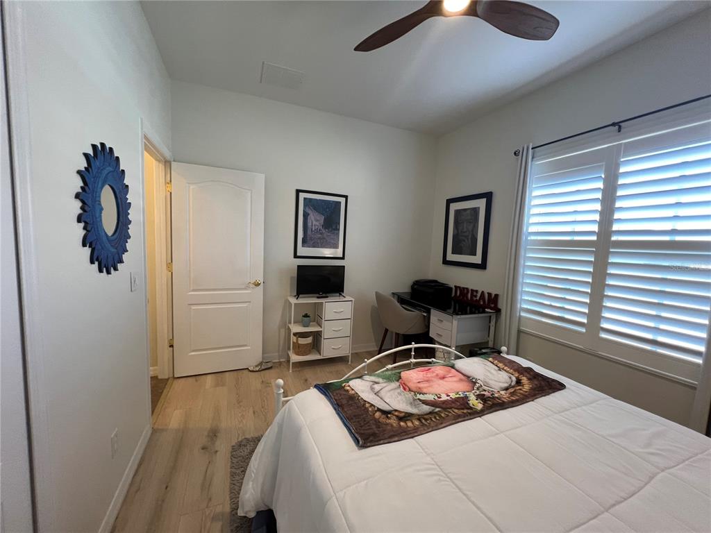 24401 Manchester Trail Port Charlotte, FL 33980 - Photo 30 of 47 a bedroom with a bed and a chandelier
