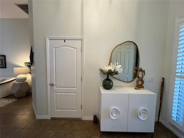 a living room with furniture a rug and white walls