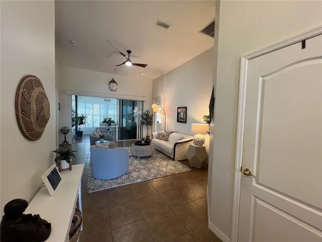 a living room with furniture and a potted plant