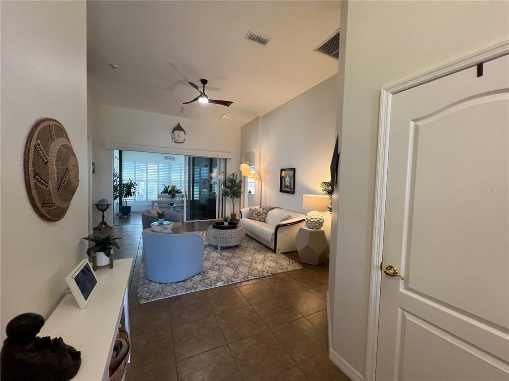 24401 Manchester Trail Port Charlotte, FL 33980 - Photo 7 of 47 a living room with furniture a rug and white walls