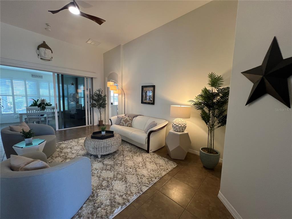 24401 Manchester Trail Port Charlotte, FL 33980 - Photo 8 of 47 a living room with furniture and a potted plant