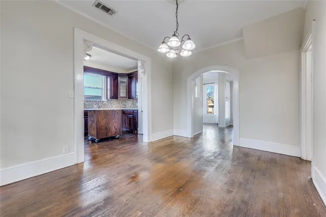 a view of a livingroom with a furniture wooden floor and chandelier