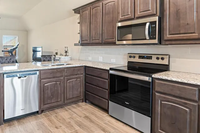 a kitchen with a stove microwave and cabinets