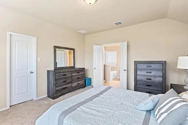 a bedroom with a bed and a dresser
