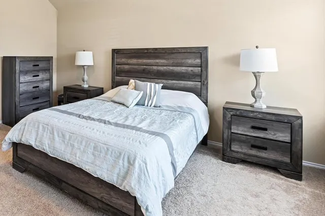 a bedroom with a bed and a lamp