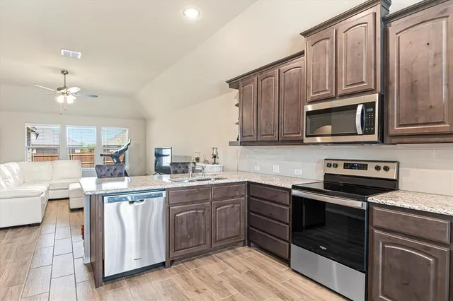 a kitchen with a sink stove and microwave