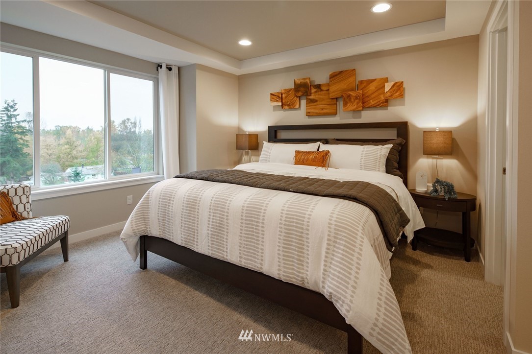623 238th Place Southeast, Unit D Bothell, WA 98021 - Photo 15 of 19 a bedroom with a bed and glass window