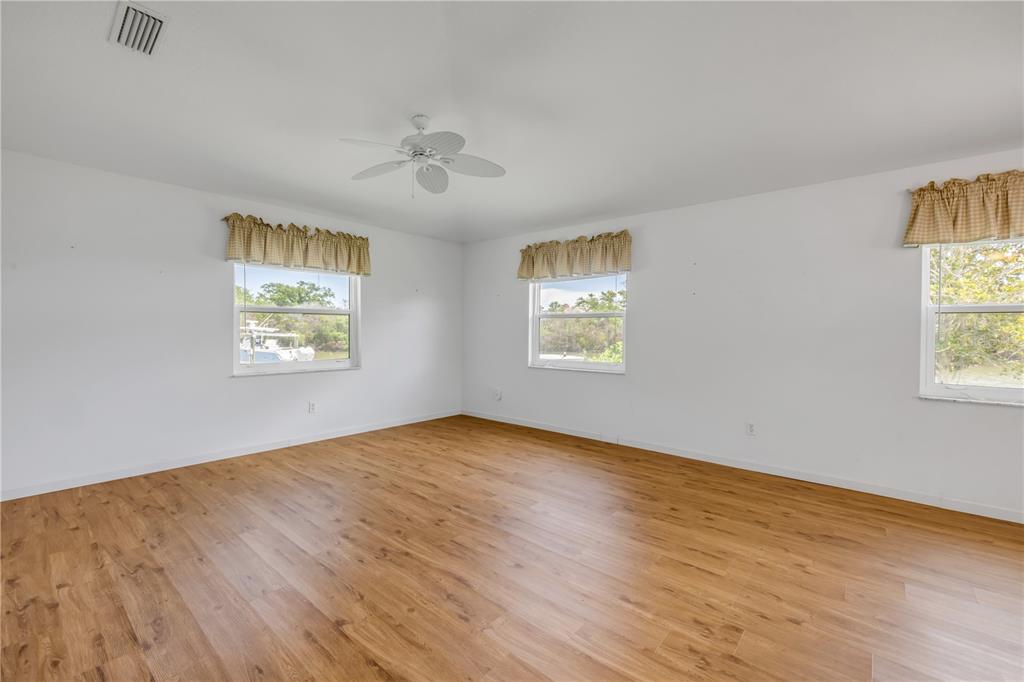 192 Azalea Road Edgewater, FL 32141 - Photo 36 of 94 a view of an empty room with a window and wooden floor
