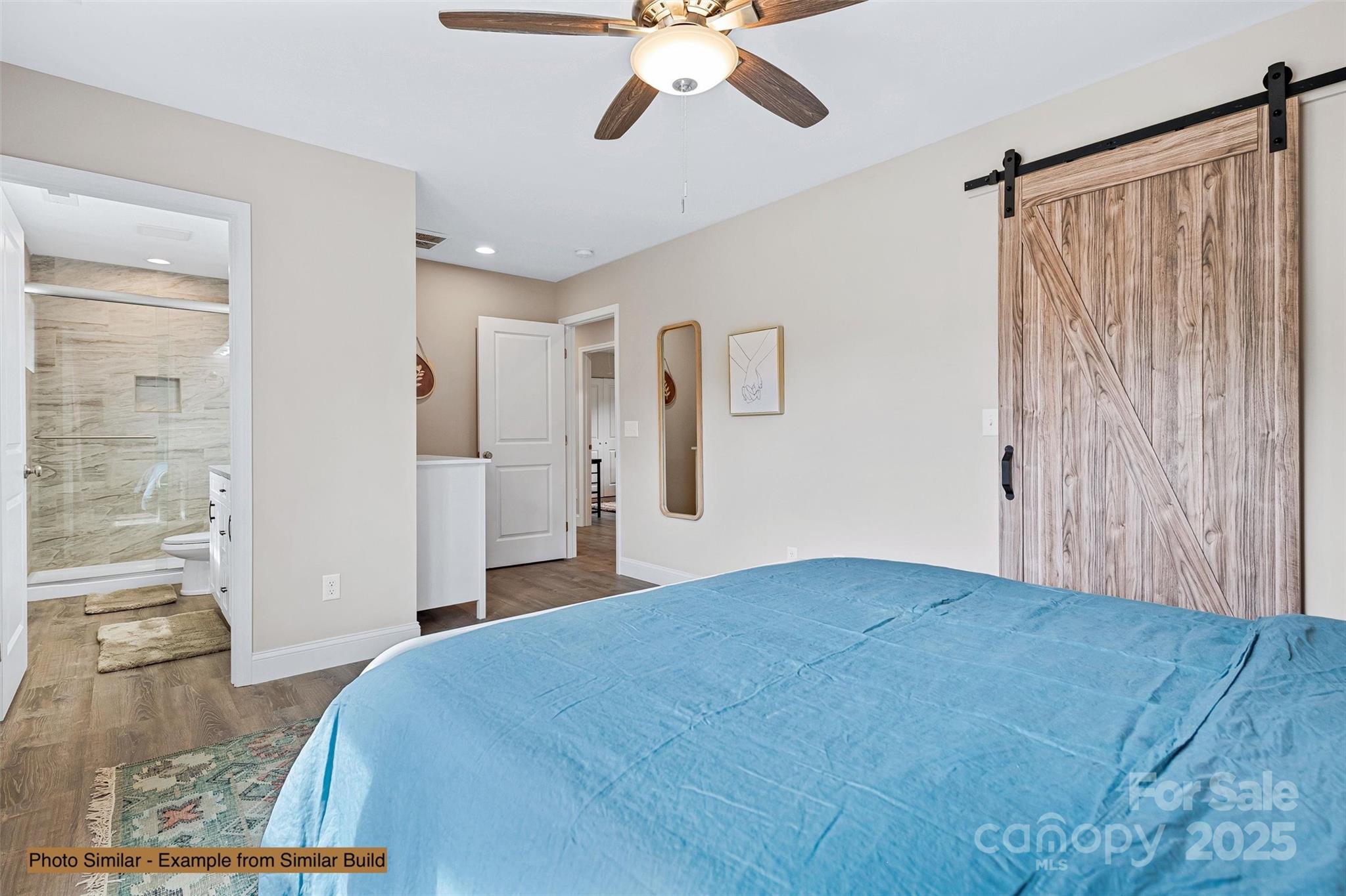 145 Burley Ridge Candler, NC 28715 - Photo 24 of 43 a bedroom with a bed and a chandelier
