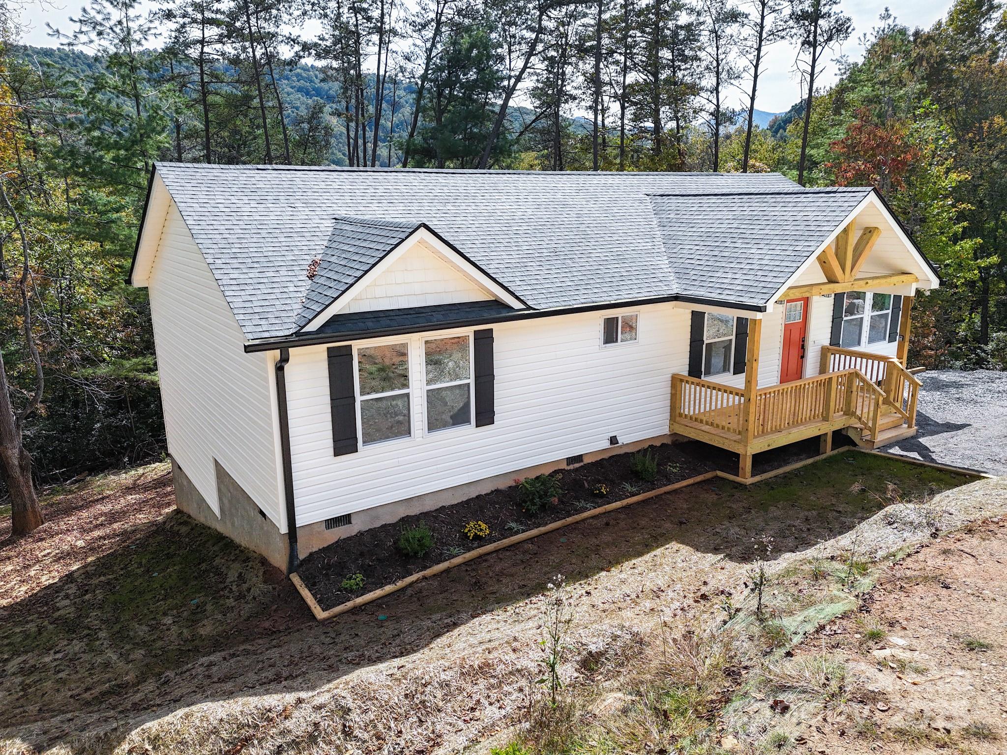 145 Burley Ridge Candler, NC 28715 - Photo 3 of 43 a view of a house with a yard covered in snow