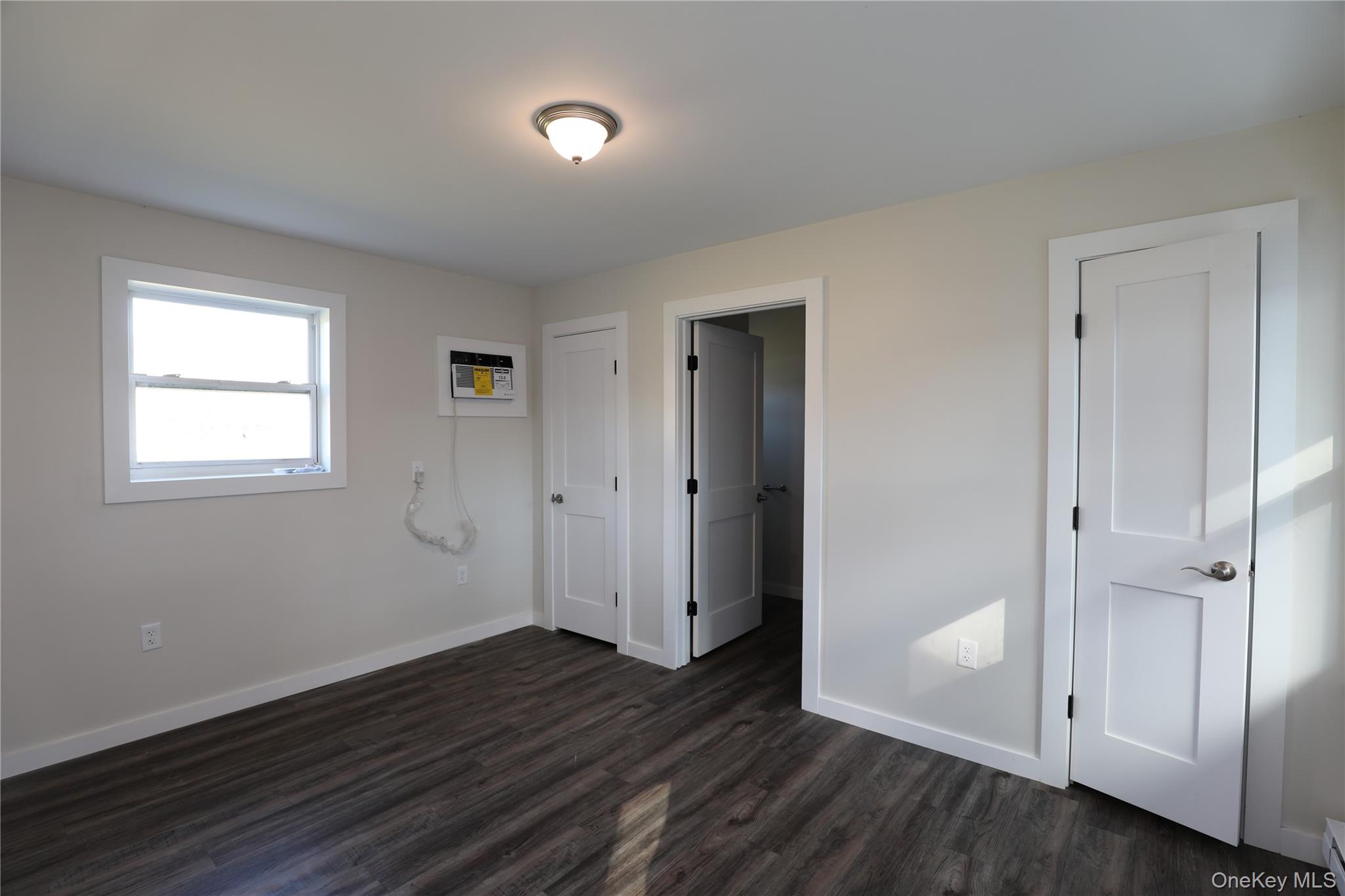 14311 Rte 9W, Unit 2 Ravena, NY 12143 - Photo 4 of 9 an empty room with wooden floor and windows