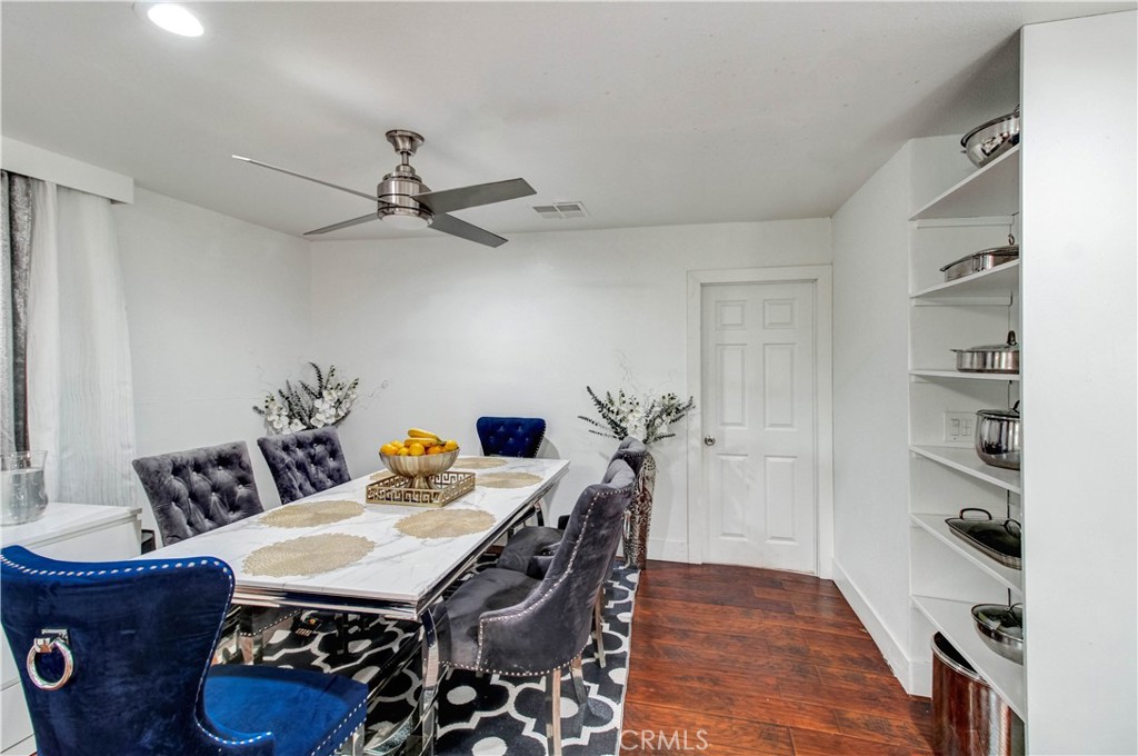 1025 South Riverside Avenue, Unit 26 Rialto, CA 92376 - Photo 11 of 27 a view of a dining room with furniture wooden floor and a chandelier