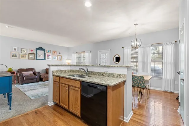 a view of living room with granite countertop furniture and wooden floor
