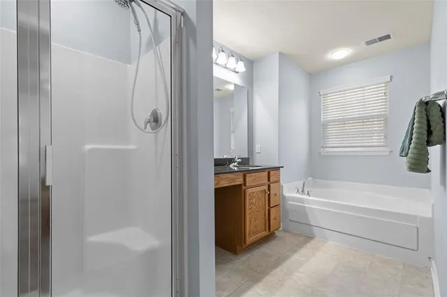 a bathroom with a tub shower and sink