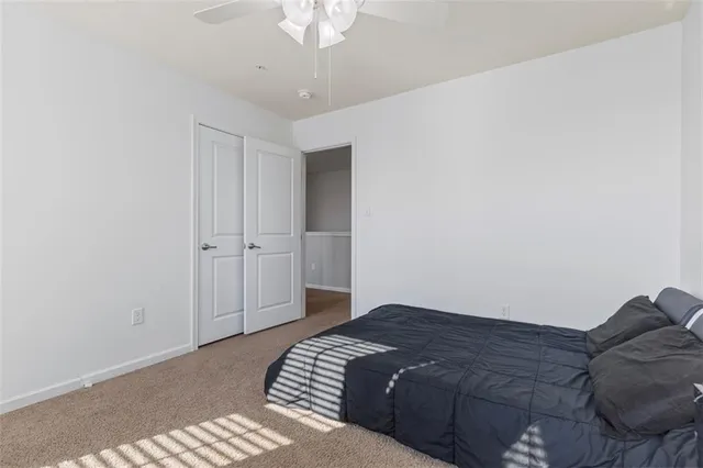 a spacious bedroom with a bed and a chandelier