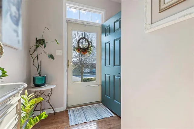 a view of an entryway with wooden floor