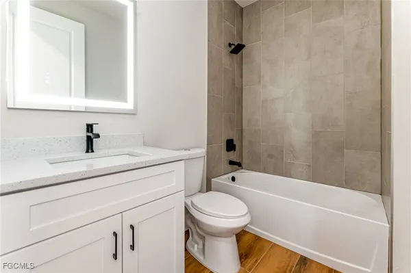 a bathroom with a sink toilet and shower