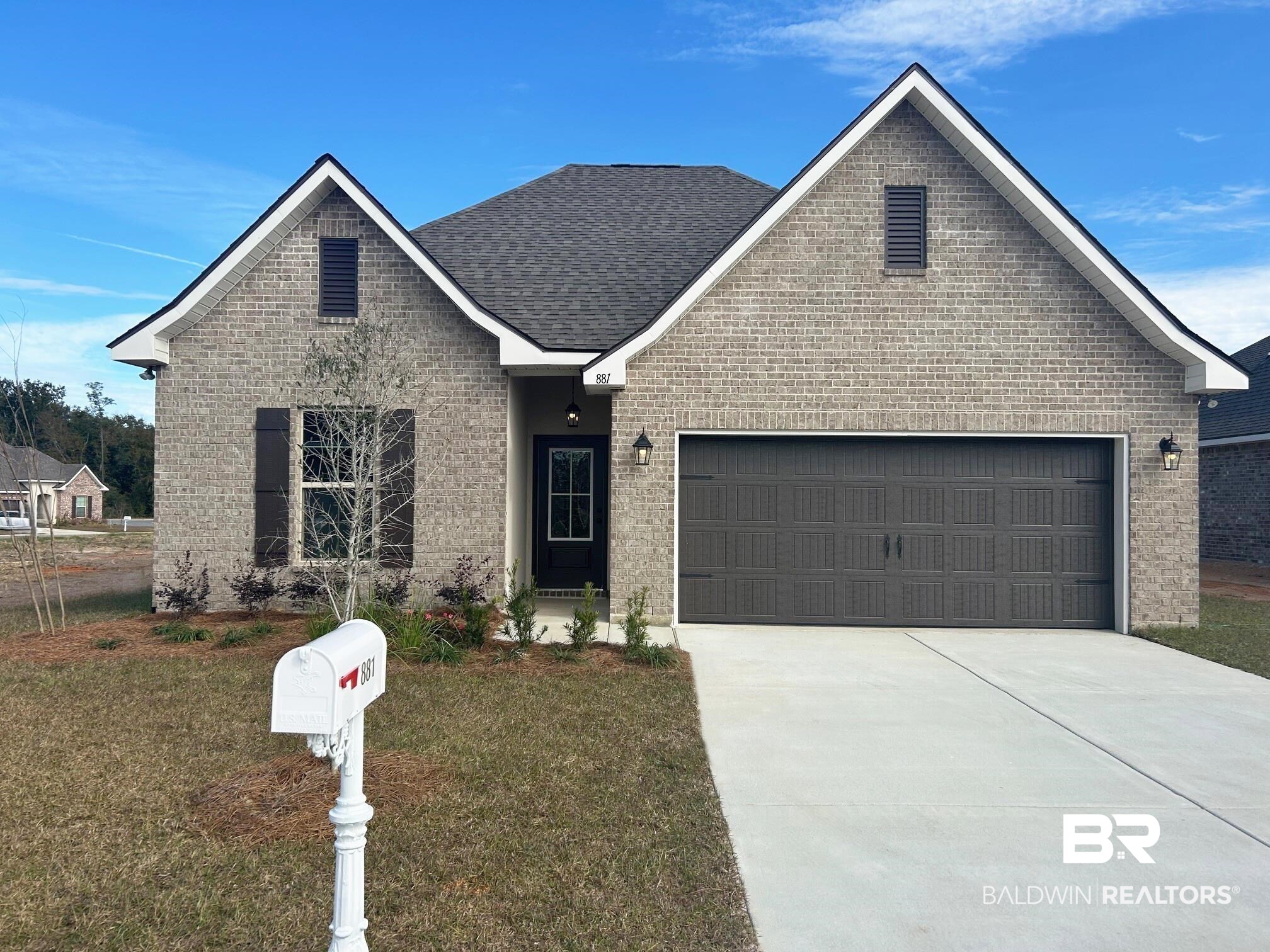 View of front of property with a front lawn and a garage