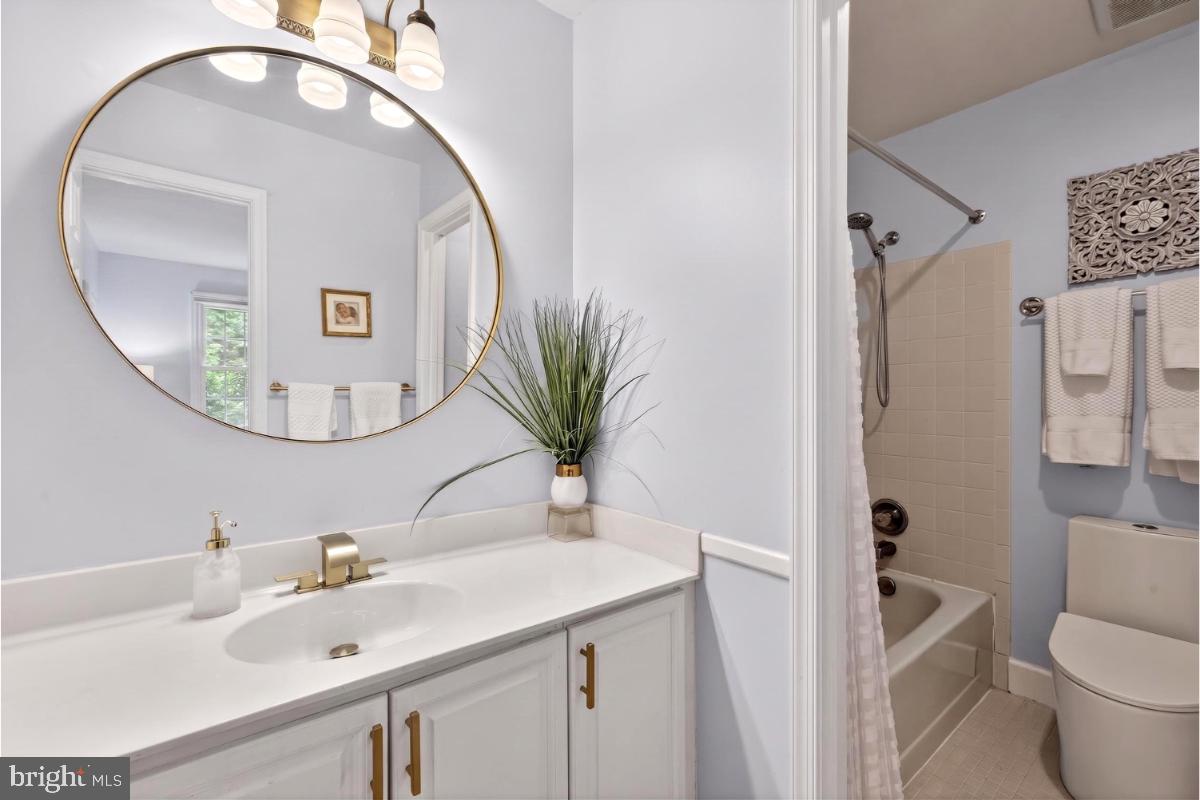 7347 Swan Point Way, Unit 122 Columbia, MD 21045 - Photo 22 of 54 a bathroom with a sink a mirror a toilet and a window