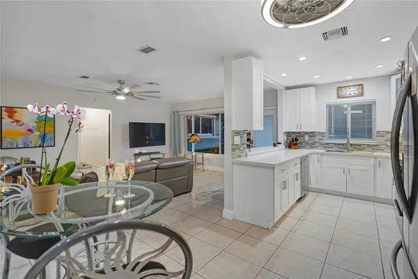 a kitchen with furniture a refrigerator and a stove top oven