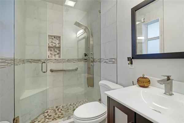 a bedroom with a bed and a flat tv screen on dresser