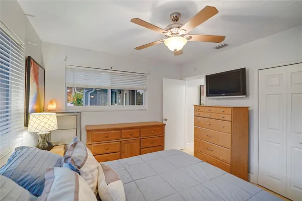 a bedroom with a bed and a chandelier