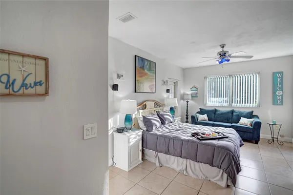 a bedroom with a bed couch and a window