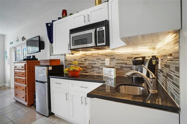 a spacious bedroom with a bed and a flat screen tv